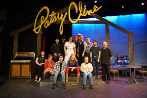 Cast and crew sitting on stage