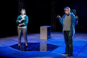 A production photo of the Curious Incident of the Dog in the Night-Time, Christopher and Siobhan are seen on stage